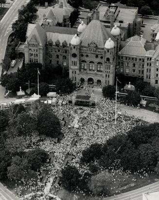 Freedom fans: A crowd of 30,000 packs the lawn outside the Legislature buidling yesterday to hear Nelson Mandela's stirring speech