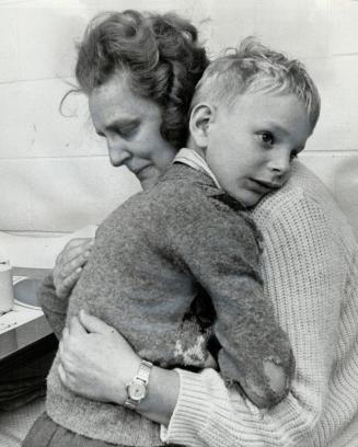 Moment of heartbreak: Mrs. Jennie Marriott and her 8-year-old son, Glen, collapse in each other's arms after she had to tell her family they would hav(...)