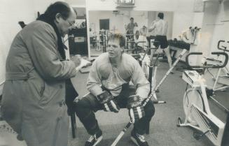 The Star's Rick Matsumoto takes down comments of Gary Leeman in Leafs' new interview room, which does double duty as team's weight training area. Owne(...)