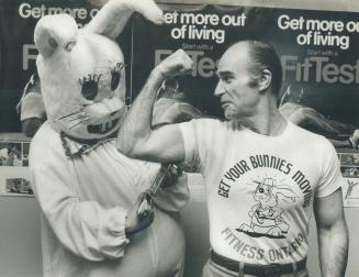 Muscling into fitness. Rich, the overweight Easter Bunny, sizes up fitness enthusiast Bruce McCaffrey, Amourdale MPP and parliamentary assistant to Ro(...)