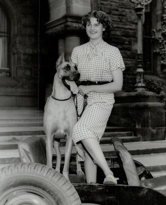 Merlyn Massey, daughter of Denton Massey, is shown with Champion Fingard's Duchess, which has been entered in the Canadian National Exhibition dog sho(...)