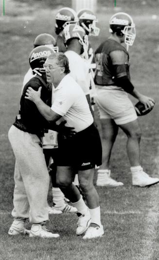 Halfback hoedown? It may look like it, but coach Don Matthews isn't showing this unidentified Argo a new dance step