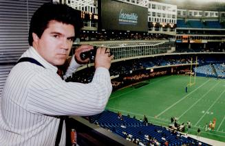 Eye on fans: Argo general manager Mike McCarthy in SkyDome box checks out viewers under glass in restaurants and hotel who paid little or nothing to see the game