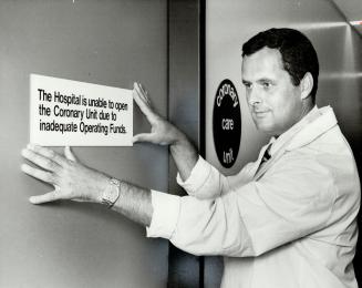 Dr. George McAllister checks sign on Humber Memorial Hospital's coronary care unit