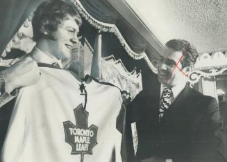 Lanny McDonald, who has been signed to highest contract ever paid junior draft choice, tries on Leafs sweater