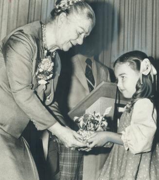 Celebrating the Queen's Jubliee, 4-year-old Deidre Lopes presents Lieutenant-Governor Pauline McGibbon with a potted plant as a token of her classmate(...)