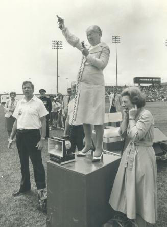 Duck! Lt.-Gov. Pauline McGibbon winced as she cracked the starter's pistol at the Colgate Ladies' track meet at Etobicoke Centennial Stadium yesterday(...)