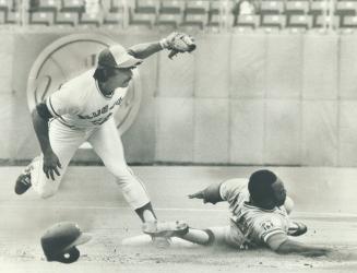 Putting his feet to work, Blue Jays' second baseman Dave McKay catches Al Oliver stealing during yesterday's game at Exhibition Stadium. McKay used hi(...)