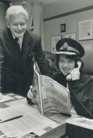 Sara at the helm: Sara Henderson-Neale, 12, jumps right into her job as police chief for a day yesterday at the desk of Chief William McCormack