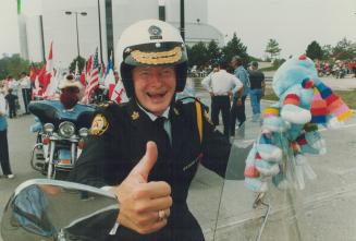 Leader of the pack. Metro police chief-designate Bill McCormack gives the thumbs-up sign as he prepares to fire up his motorcycles as the Blue Knights(...)
