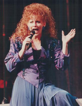 Cosmo-cornpone: Reba McEntire may look sophisticated, but she's a four-time Country Music award winner and a former rodeo barrel racer