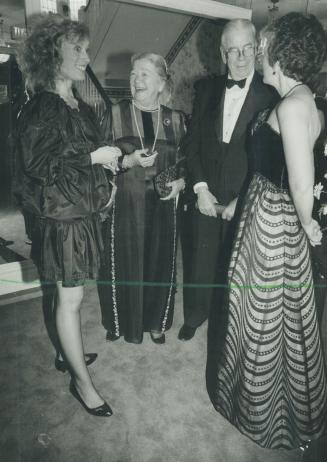 Above, left to right, Helena Flygare, former lieutenant-governor Pauline McGibbon and her husband Don McGibbon admire gown by Tricia Cochrane modelled by Susan Bright