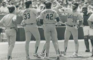 What a bash! Terry Steinbach (36) gives an A's-style high-five to Mark McGwire as Dave Henderson and Jose Canseco await their turn after Steinbach's slam. Greg Myers can't look