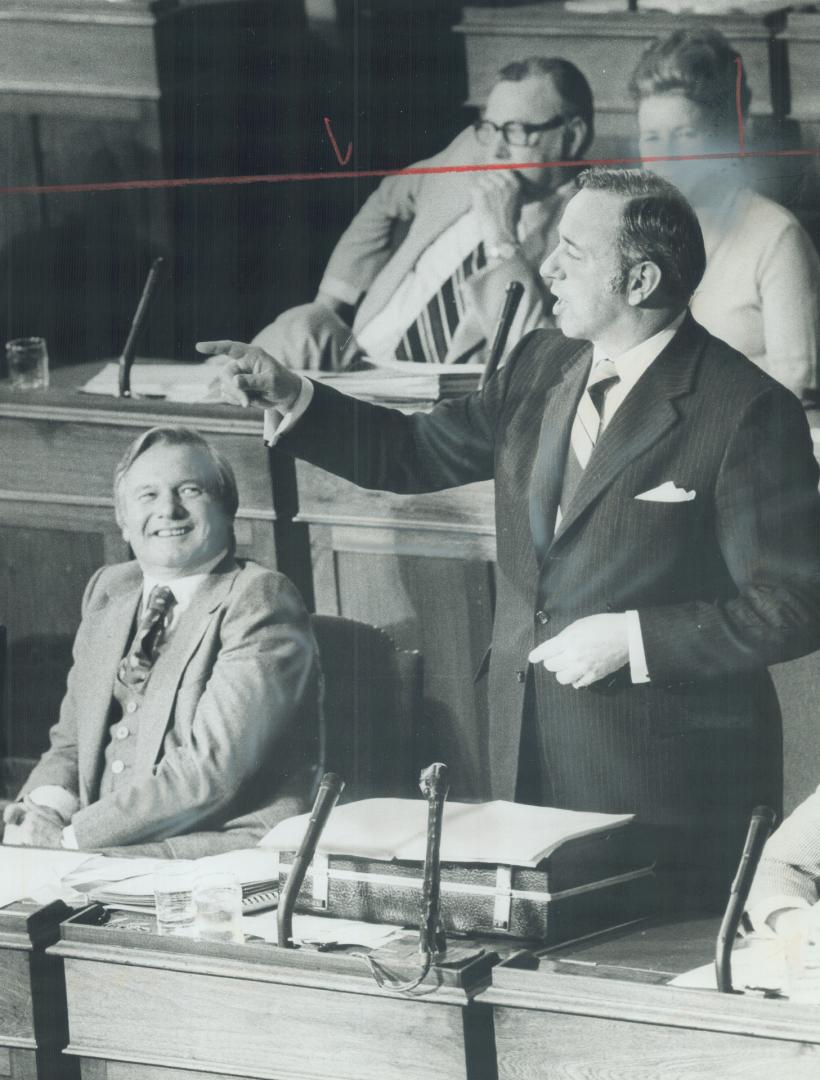 Provincial treasurer Dary McKeough shakes his finger across Legislature at opposition benches, as Premier William Davis looks on grinning, during budg(...)