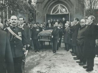 Draped in Canadaian flag, the casket of Col
