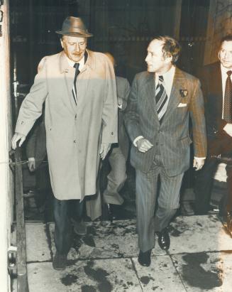 A matter of communication. Prime Minister Pierre Trudeau and University of Toronto professor and author Marshall McLuhan leave a restaurant at Windsor(...)