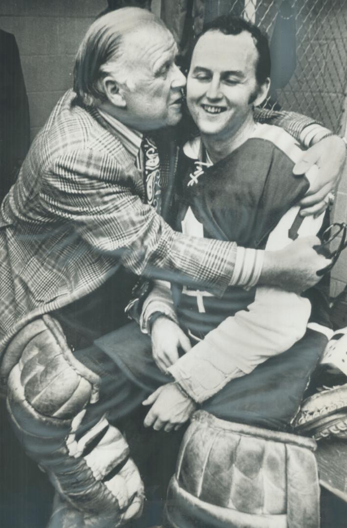 A hug for the leafs' hero. Overjoyed by Leafs' 2-1 victory last night over Los ANgeles Kings, team owner Harold Ballard hugs 27-year-old rookie goalte(...)