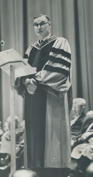 Retiring chief justice J. C. McRuer, shown speaking to Osgoode graduates, received an honorary doctorate of laws at yesterday's ceremony