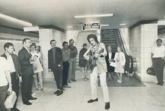 Subway Elvis plays a song at the Yonge Bloor subway station, which is where the people are