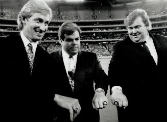 Three-Ring circus: Argos owners Wayne Gretzky, Bruce McNall and John Candy, left to right, show off Grey Cup rings at home opener
