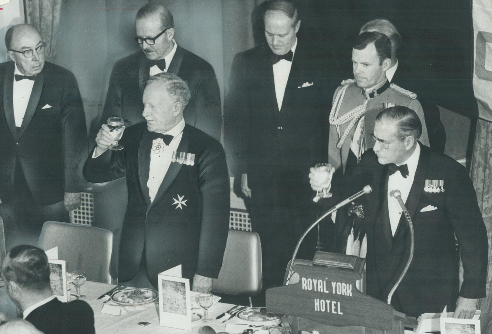 Queen's representative in Canada, Governor-General Roland Michener raises galss in a toast to Her Majesty last night in Empire Club dinner at which he(...)