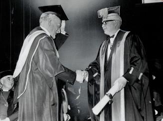 His excellency, the doctor. Governor-General ROland Michener (left) receives honorary fellowship in College of Physicians and Surgeons of Canada from (...)