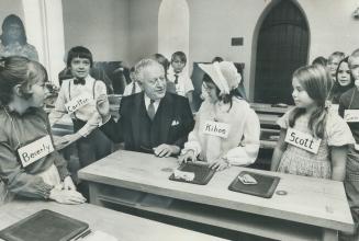 Governor-general Roland Michener talks with children dressed in 19th century style at official opening of the restored Enoch Turner School, built in 1(...)