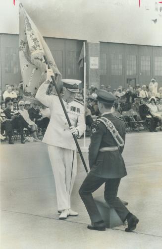 Battle honors given. In white uniform, Governor-General Roland Michener presents battle honors standrad to Lt. Michael Sheppard, of 411 (County of York) Air Reserve Squadron on Sunday