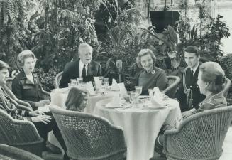Governor-General Michener and Mrs. Michener, right, preside over an informal luncheon beside the goldfish pool and fountains in the greenhouse in Ride(...)