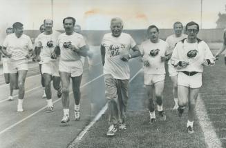 One step in front of the rest of the field, Governor-General Roland Michener leads a group of heart patients as they jog four miles around the track a(...)