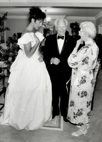 Far left, Patricia Scott, daughter of University Women's Club executive director Patricia Walker, models a Tom D' Auria gown for former governor-general Roland Michener and Margaret McKellar
