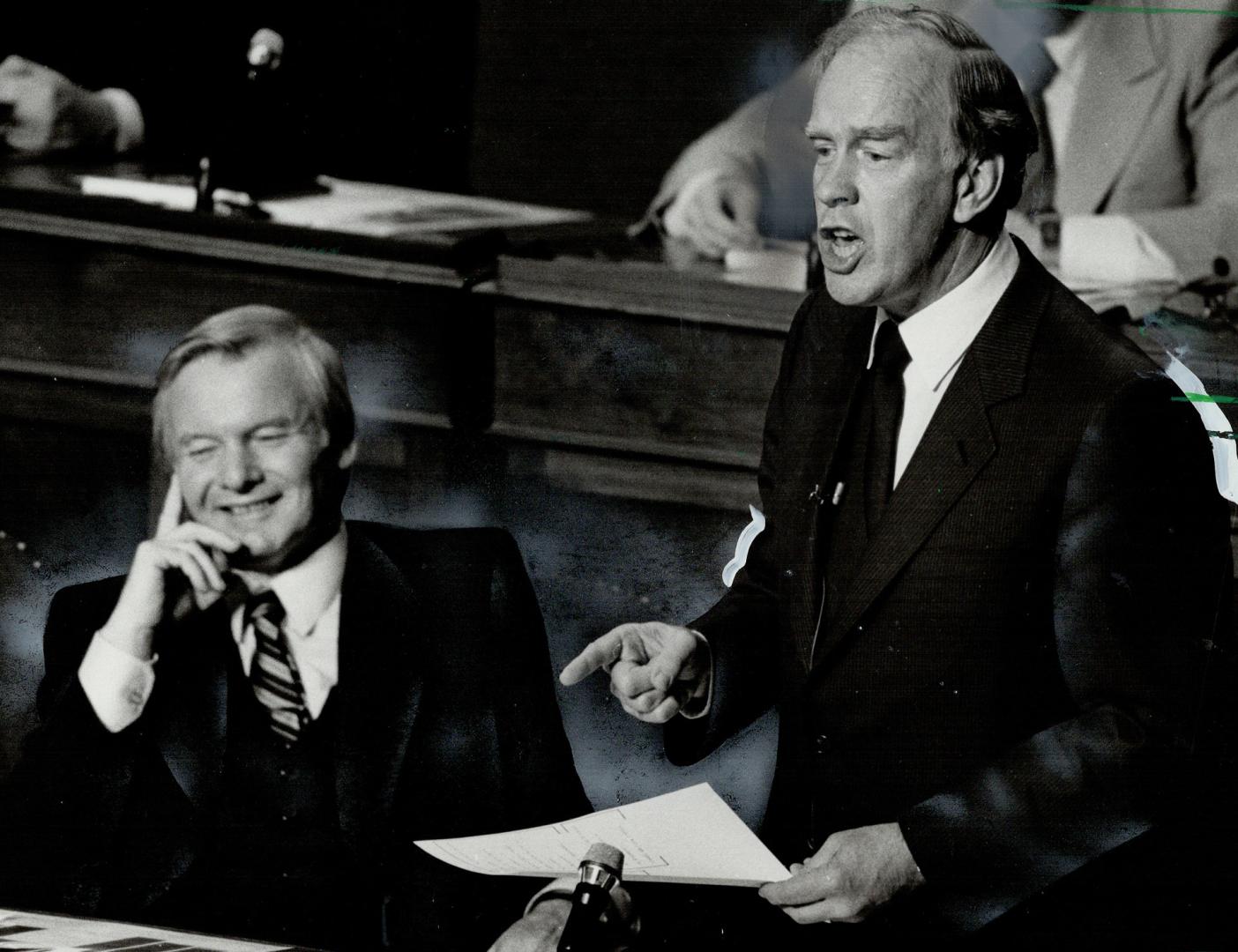 Laughing the blues away? Premier William Davis appears to be smiling as Treasurer Frank Miller announces his budget plans for the coming year. Miller,(...)