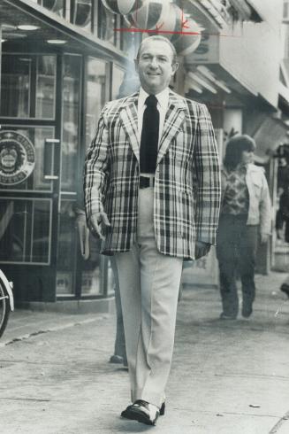 Ed Mirvish, entrepreneur, wears Donegal tweed jacket designed for a long, slim look with front edges of coat cut straight instead of curved