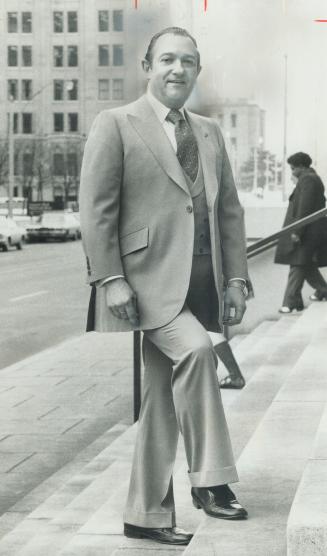 Ed Mirvish, entrepreneur, models a rose garbardine suit with a double-breasted vest