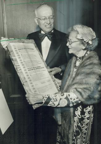 Rabbi David Monson shows mother, Jennie Monson, 86, citation presented to him by Canadian Shaare Zedek Foundation for his support for Jerusalem's Shaa(...)