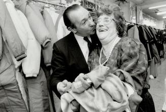 Honest-to-goodness kiss: Lorraine Randell gets an appreciative buss from Ed Mirvish of Honest Ed's department store, where she's worked for 37 years
