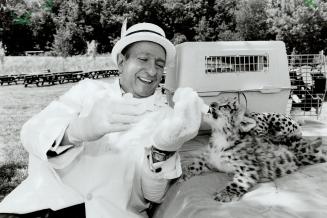 It's good for you - honest. Honest Ed Mirvish feeds milk from a baby bottle to a month-old female snow leopard at the Metro zoo yesterday. Toronto Pre(...)