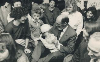 Victory bash: Dr. Henry Morgentaler holds his 2 1/2-week-old son Benjamin as his wife, left, and other supporters surround him during celebrations aft(...)