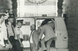 Victory sign: Dr. Henry Morgentaler holds up his fingers in a V for victory sign as he prepared to climb into a police paddy wagon to be taken from ol(...)