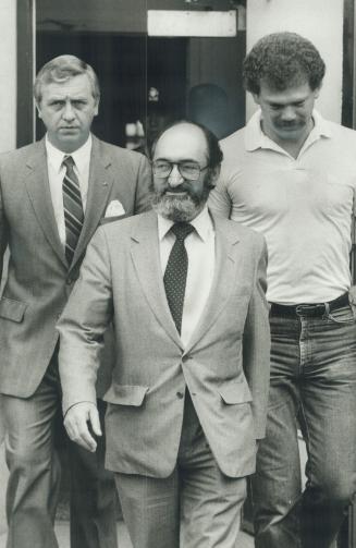 Surrenders to police: Dr. Henry Morgentaler (middle) leaves Metro Police headquaters today after being fingerprinted and photographed. He is charged w(...)