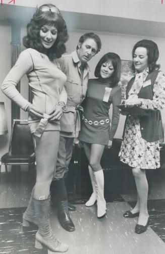 Actress Nicole Morin, wearing hot pants, pins on her Mental Health Association tag watched by Don Harron, Marie Andre and Mrs. Knowlton Nash at a Vari(...)