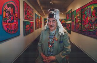 Norval Morrisseau is a picture of the artist at ease, decked out in a spectacular ermine headdress