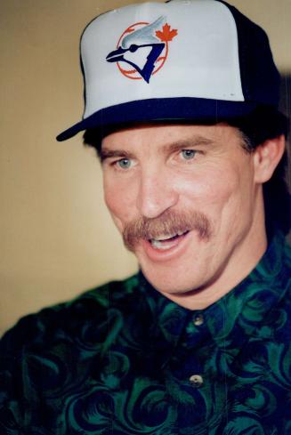 Free-agent pitcher Jack Morris tries a new hat on for size after signing a multi-million-dollar deal with Toronto Blue Jays yesterday