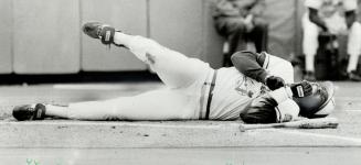 And Lloyd Moseby of the Jays, bottom, winces after he was hit by a pitch