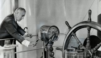 The admiral back at the helm, Admiral of the Fleet Earl Mountbatten swings the handle of an old ship's engine room telegraph to 'full ahead' during hi(...)