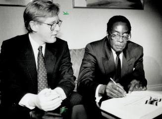 Mugabe records Metro visit. Robert Mugabe signs Ontario's guest book in his hotel suite today, before attending an official government luncheon held i(...)