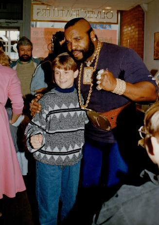 Going For Gold: Mr. T is a hit with a young fan at a Cumberland St. jewelry store promotion. The larger-than-life actor shone at the event