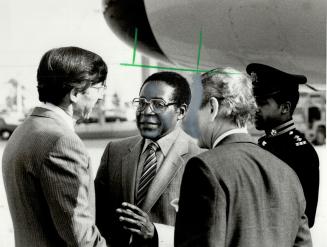 Zimbabwe PM arrives in Metro. Robert Mugabe (middle) is greeted by Roy MacLaren (left), federal minister of state for finance, and Norman Sterling, pr(...)