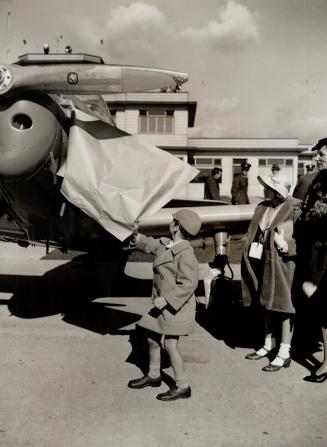 Crown Prince Harald, 5, heir to the throne of Norway, whips the covering off a new elementary training plane at Little Norway. Five of the planes were(...)