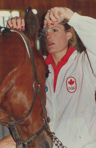 Good Grooming, Olympic bronze medalist Ashley (Nicoll) Munroe combs the forelock of her 9-year-old gelding Rebell